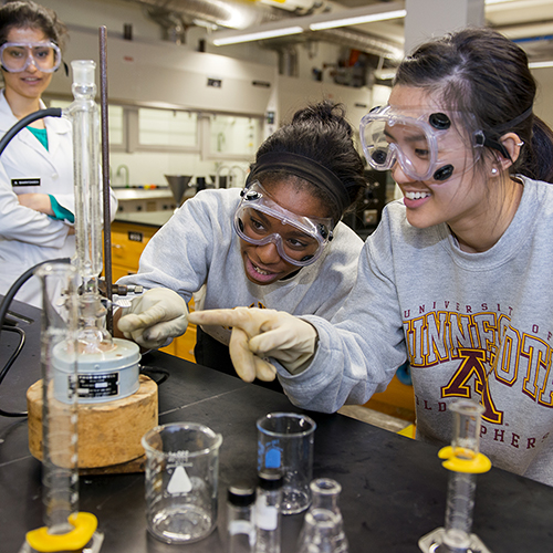 Students examine a test tube in a lab